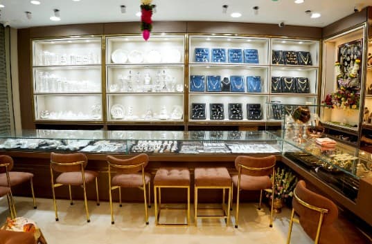 Showroom counter with cushioned seating and glass display cases