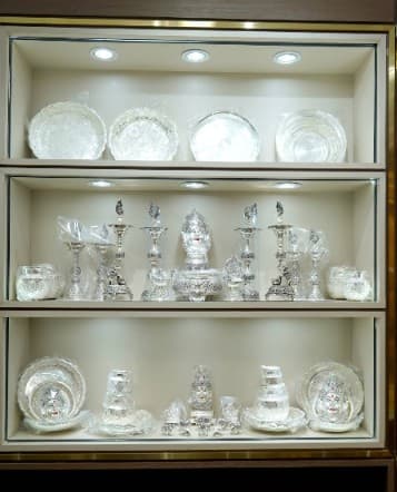 Silver lamps, plates and idols displayed in the silver niche